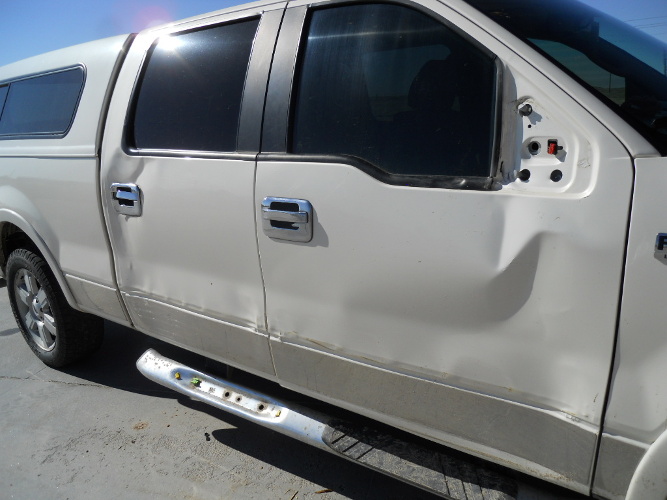 Pickup truck with body damage awaiting repair